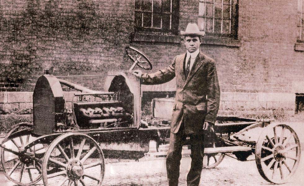 Charles R. Patterson standing in front of one of his automotive creations.